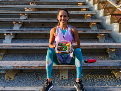 Confident athlete with prepped vegan meal after training